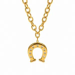 Gold-toned horseshoe pendant necklace with square zircon stones on a chunky chain.