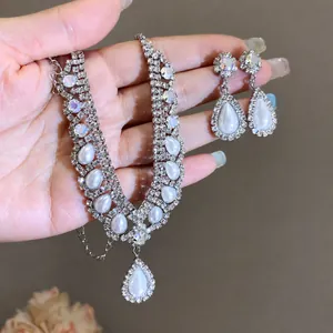Elegante set di gioielli con collana e orecchini a goccia con perle e strass