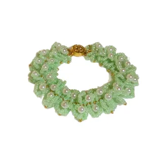 Chic mint green resin beaded flower bracelet featuring white pearls and a gold clasp detail