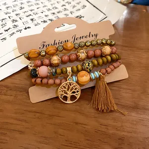 Detailed view of bohemian style beaded bracelet set with tree of life charm and tassel