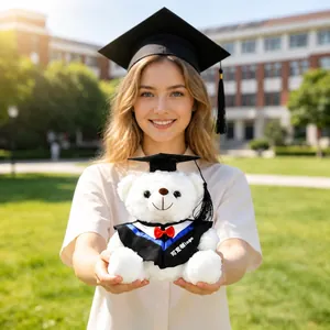 Close-up of white graduation teddy bear plush in academic gown with graduation cap