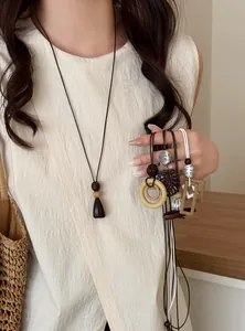 Elegant long pendant necklaces with geometric wood and metal accents in New Chinese style