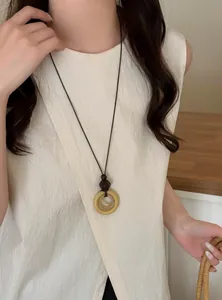Detail view of a vintage New Chinese style long pendant necklace featuring wooden circles