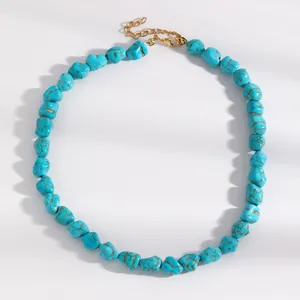 Detailed view of irregular turquoise beads and gold-tone adjustable lobster clasp