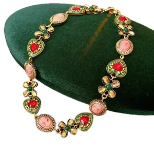 Vintage court style necklace with cameo pendants and red heart charms in gold finish