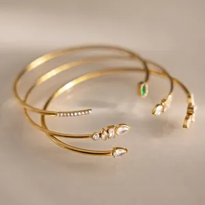 Three 18k gold plated stainless steel open cuff bracelets with various zircon shapes