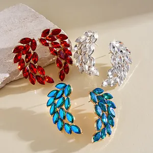 Close-up of elegant feather-shaped rhinestone earrings in red, white, and blue hues