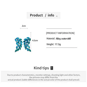 Close-up detail of blue rhinestone feather earrings with dimensions and material info
