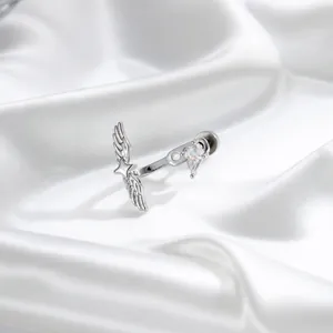 Elegant silver angel wing titanium ear stud with kite-shaped crystal on white silk