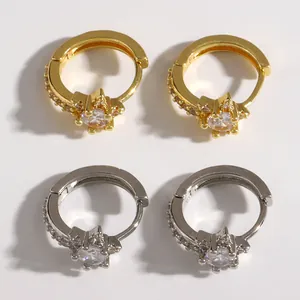 Detail of gold and silver star micro-pave hoop earrings with sparkling stones