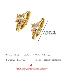 Detail view of gold star micro-pave crystal huggie earrings with specifications