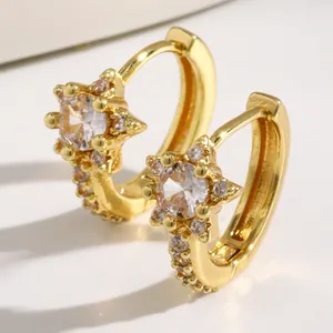 Macro detail of gold-tone star hoop earrings with micro-pave clear zircon stones