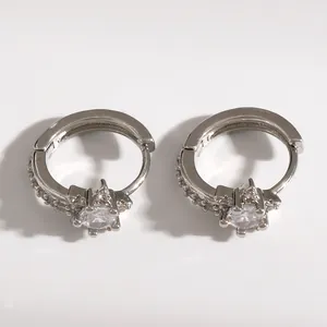 Detailed close-up of silver-tone star hoop earrings featuring micro-pave sparkling crystals