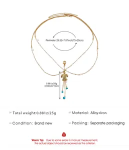 Detailed view of gold multi-layer body chain with turtle pendant and pearl accents