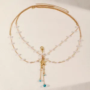 Exquisite detail of golden starfish charm and blue bead accents on layered pearl body chain