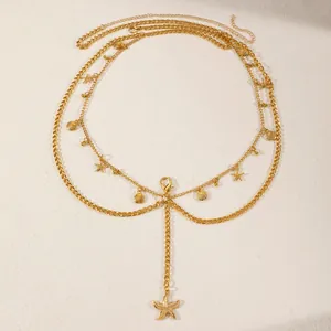 Close-up of elegant golden multilayer body chain with starfish and shell pendants