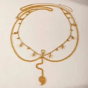Macro detail of sexy gold multi-layer body chain with seashell and starfish pendants