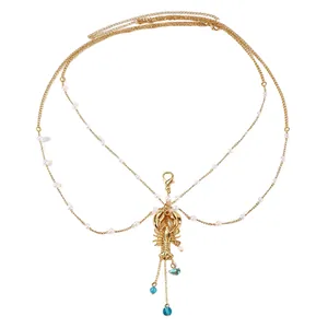 Detailed view of a gold multi-layer body chain featuring a lobster pendant and pearls