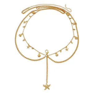 High quality detail of a multilayer gold metal body chain featuring starfish and seashell charms