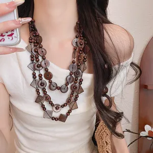 Close-up detail of bohemian multi-layered necklace with beaded coconut shell geometry