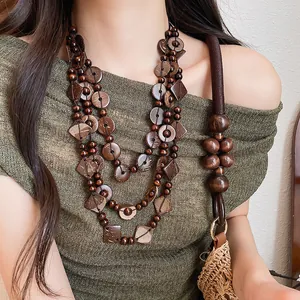 Bohemian multi-strand necklace with geometric coconut shells and wooden beads on model