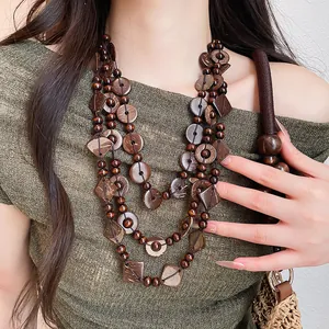 Detail of bohemian multilayer necklace made from coconut shell and geometric wooden beads.