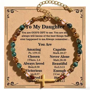 Detailed view of African turquoise bracelet with gold cross and To My Daughter card.