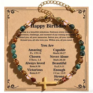 Macro view of African turquoise stone bracelet with gold cross pendant and gift card