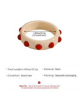 Vintage wide cream resin bangle with red 3D polka dots detail and measurement info