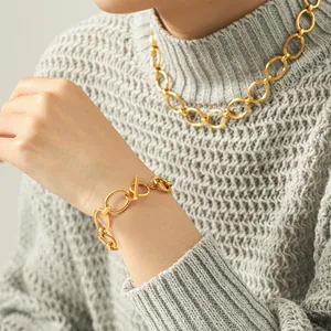 Detailed view of gold titanium steel oval link chain jewelry set with OT toggle clasp