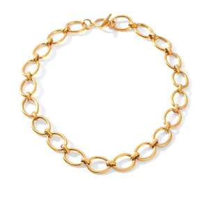 Detail shot of a gold titanium steel necklace with large oval links and a toggle clasp.