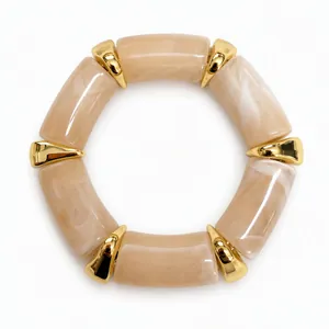 Detail showing marble pattern amber resin segments and gold-toned spacers of the bracelet