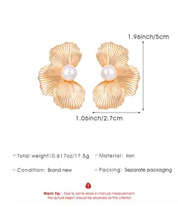 Macro view of gold flower petal stud earrings with pearl detail and size annotations