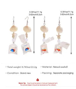 Vue détaillée de boucles d'oreilles style océan avec coquillages et étoiles de mer