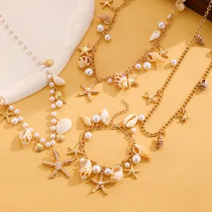 Detailed view of bohemian beach jewelry set with sea star, pearl and shell charms.