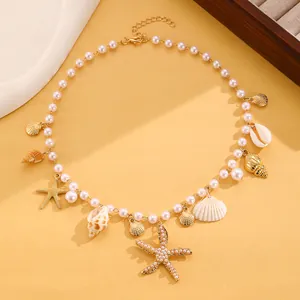 Bohemian beach necklace with faux pearls, seashells, and starfish charms detail view