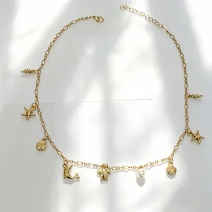 Detailed view of bohemian gold necklace featuring seashell, starfish, and sea turtle charms