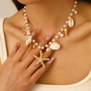 Bohemian pearl necklace featuring sea shells and a large starfish pendant on a model