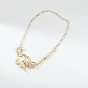 Detailed view of a gold-toned scorpion necklace with sparkling rhinestone embellishments