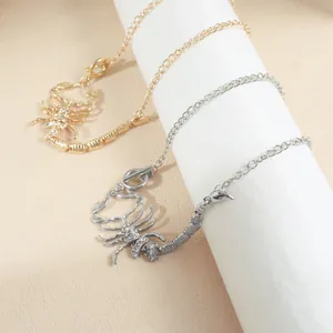 Detail view of gold and silver scorpion chokers with shimmering rhinestones for Halloween.