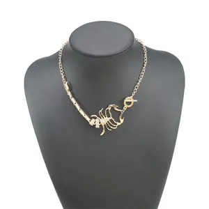 Detail of a bold gold-colored scorpion pendant necklace with sparkly rhinestones