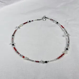 Detailed view of handmade beaded necklace with natural stones and freshwater pearls.