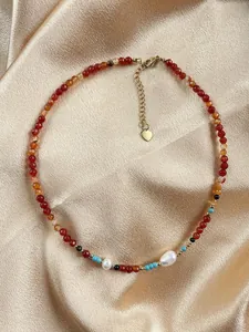 Close-up of handmade natural stone necklace with freshwater pearls and gold-tone clasp