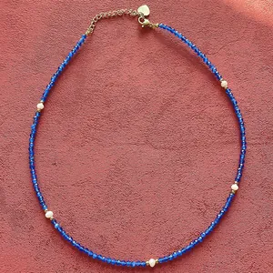 Hand-strung blue natural stone choker necklace with elegant white freshwater pearl accents.