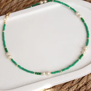 Close-up of handmade green natural stone and freshwater pearl beaded clavicle necklace