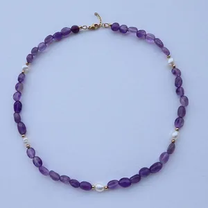 Detailed view of handmade necklace featuring purple natural stones and white freshwater pearls
