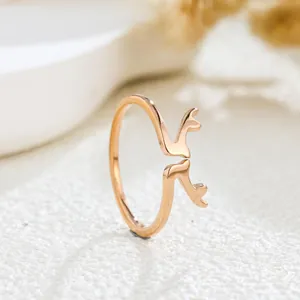 Macro detail view of a stylish rose gold open ring with delicate deer antler design motifs