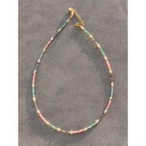 Detailed view of handmade colorful natural stone and freshwater pearl necklace