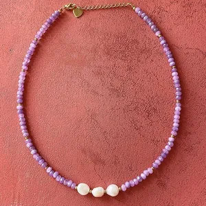 Elegant handmade purple natural stone beaded necklace with three white freshwater pearls.