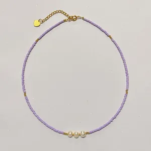 Elegant handmade purple seed bead necklace with three freshwater pearls and gold heart charm